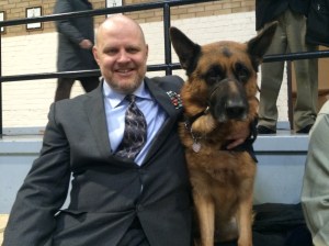 A veteran and his service dog sit up in the viewing gallery.